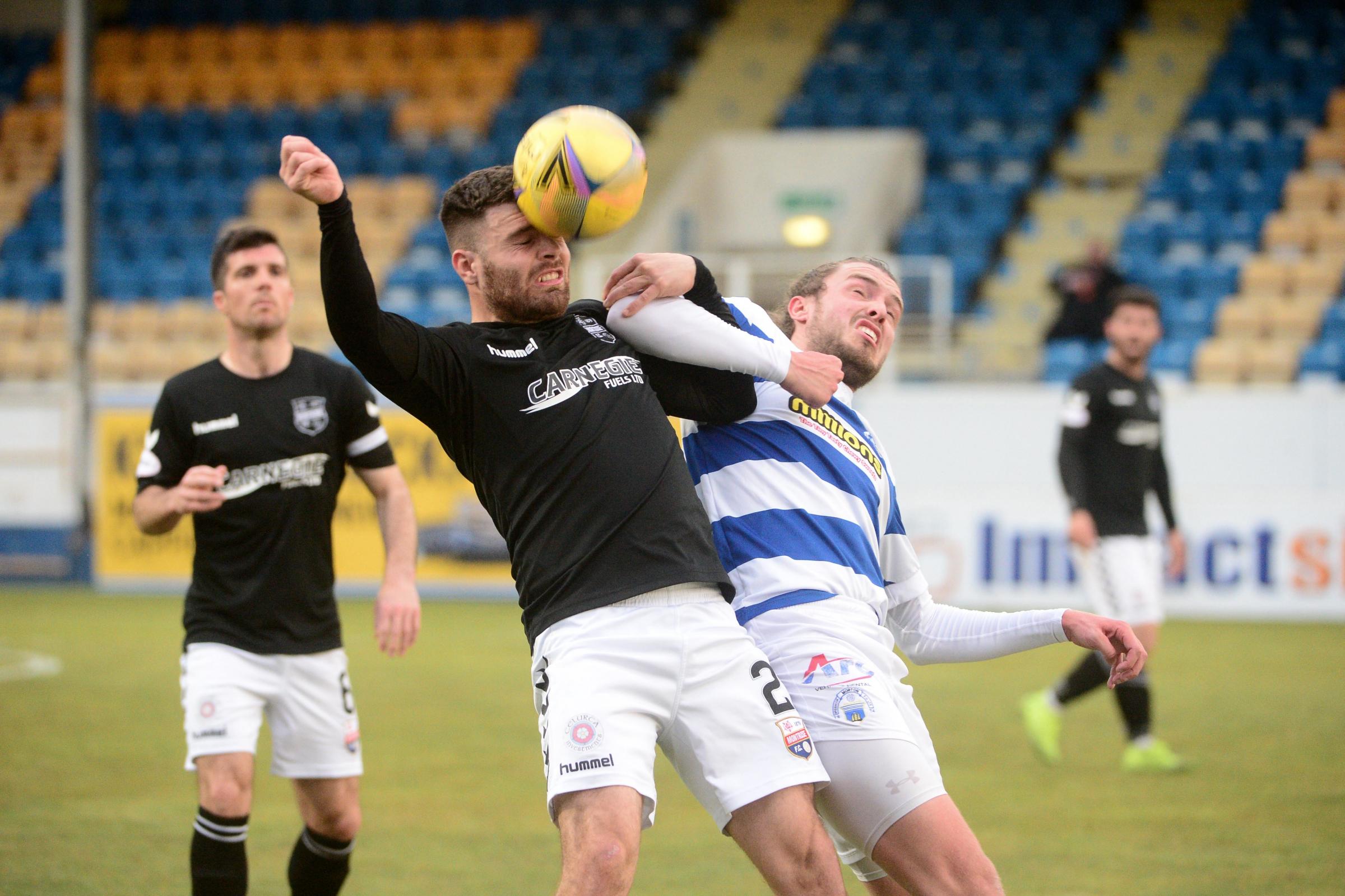 Robbie Muirhead battles for possession..