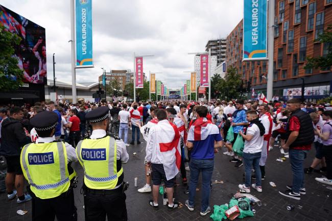 Police watch England fans outside Wembley ahead of the Euro 2020 final