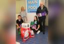 Inverclyde Amateur Swimming Club hand over donation with Claire McArthur, President, Luke Garrity, left, Honor McGeehan
