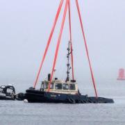 Sunken tug Biter recovered by crane barge Lara 1 off Greenock.