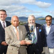 Dr Sadhu Gupta, MBE, with his son Puneet and members of the Gourock Rotary Club at the launch of the award last year
