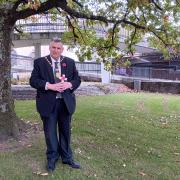 Provost Drew McKenzie at the site of the Garden of Remembrance in Clyde Square, with one of the crosses which will be laid as part of the service on Saturday