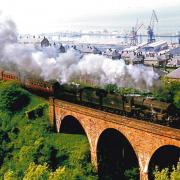 Steam train at old Nine Arches Viaduct at Devol in Port Glasgow