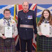 Lord Lieutenant Peter McCarthy presents awards to  Catriona Arkley and Aidan Phillips