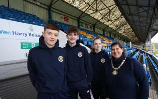 Erin O'Brien with fellow SSFA players Jamie Low and Owen Doyle, and SSFA president Gillian Duffy